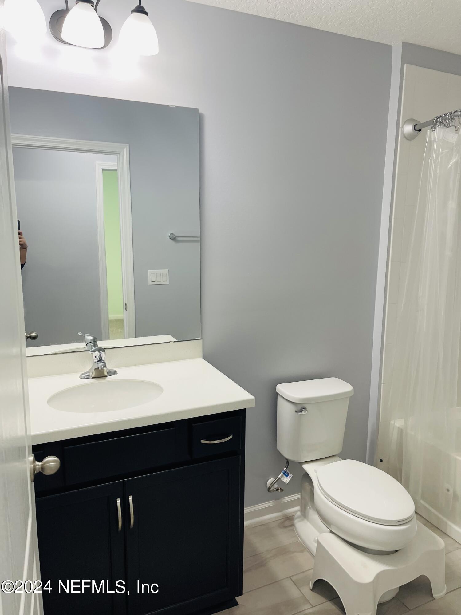 86508 Secluded Place Yulee, FL 32097 - Photo 23 of 43 a bathroom with a sink a toilet and mirror