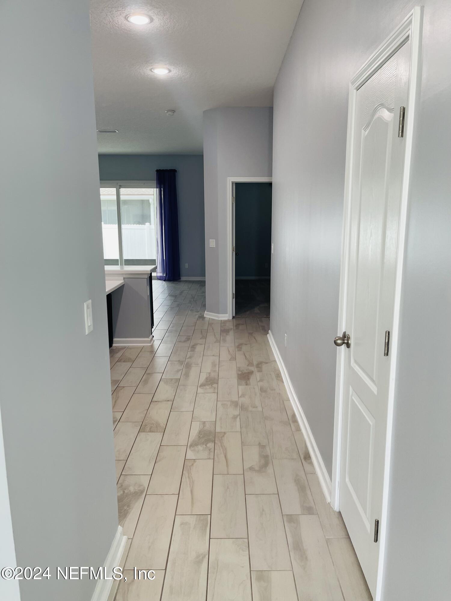 86508 Secluded Place Yulee, FL 32097 - Photo 5 of 43 a view of a hallway with wooden floor and staircase