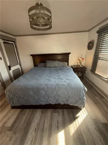 a bedroom with a bed and a chandelier