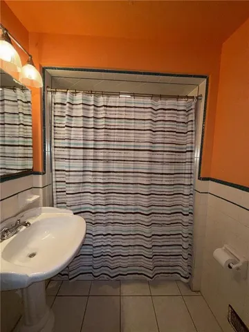 a bathroom with a sink toilet and mirror