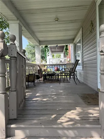 a view of a patio with table and chairs potted plants with wooden floor