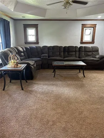 a living room with furniture gym equipment and a window