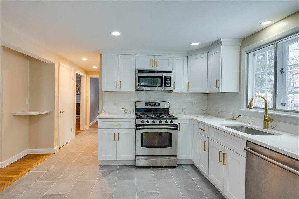 63 Dexter Road Lexington, MA 02420 - Photo 8 of 19 a white kitchen with a stove top oven and sink