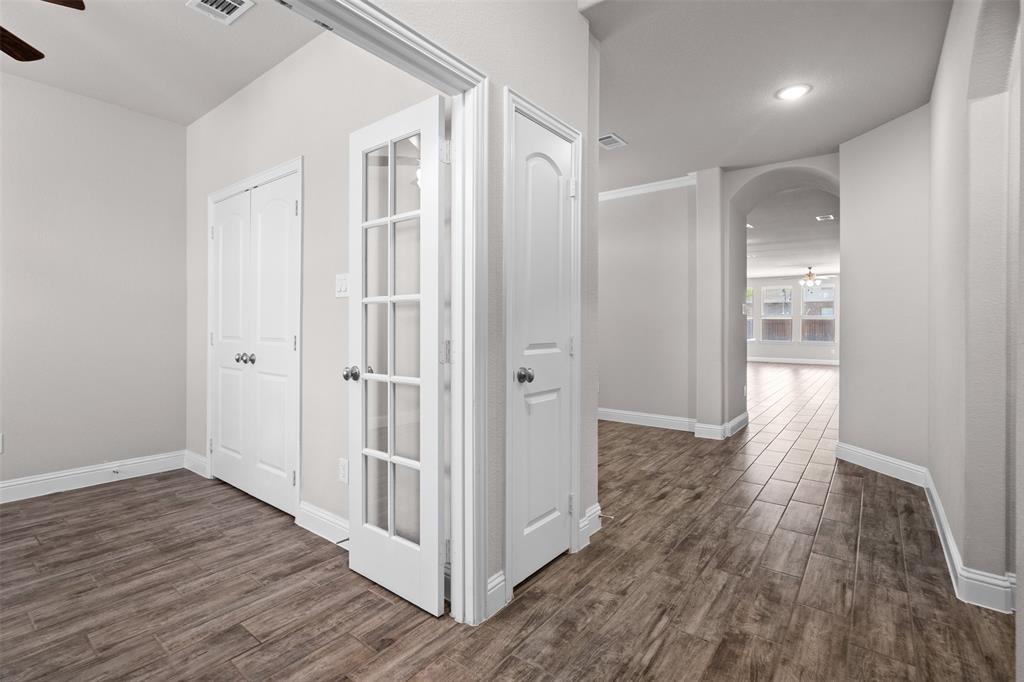 119 Happy Lane Red Oak, TX 75154 - Photo 4 of 37 French doors opening to a versatile room with wood-finish flooring