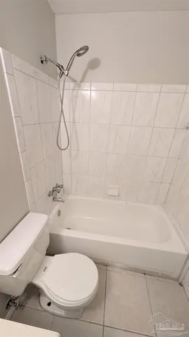 a bathroom with a toilet and a bathtub