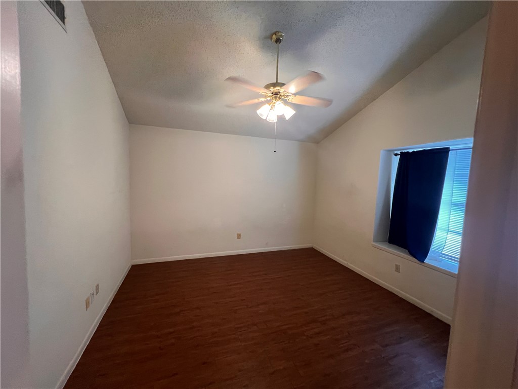 4021 Acushnet Drive, Unit F Corpus Christi, TX 78413 - Photo 16 of 21 wooden floor in an empty room with a window