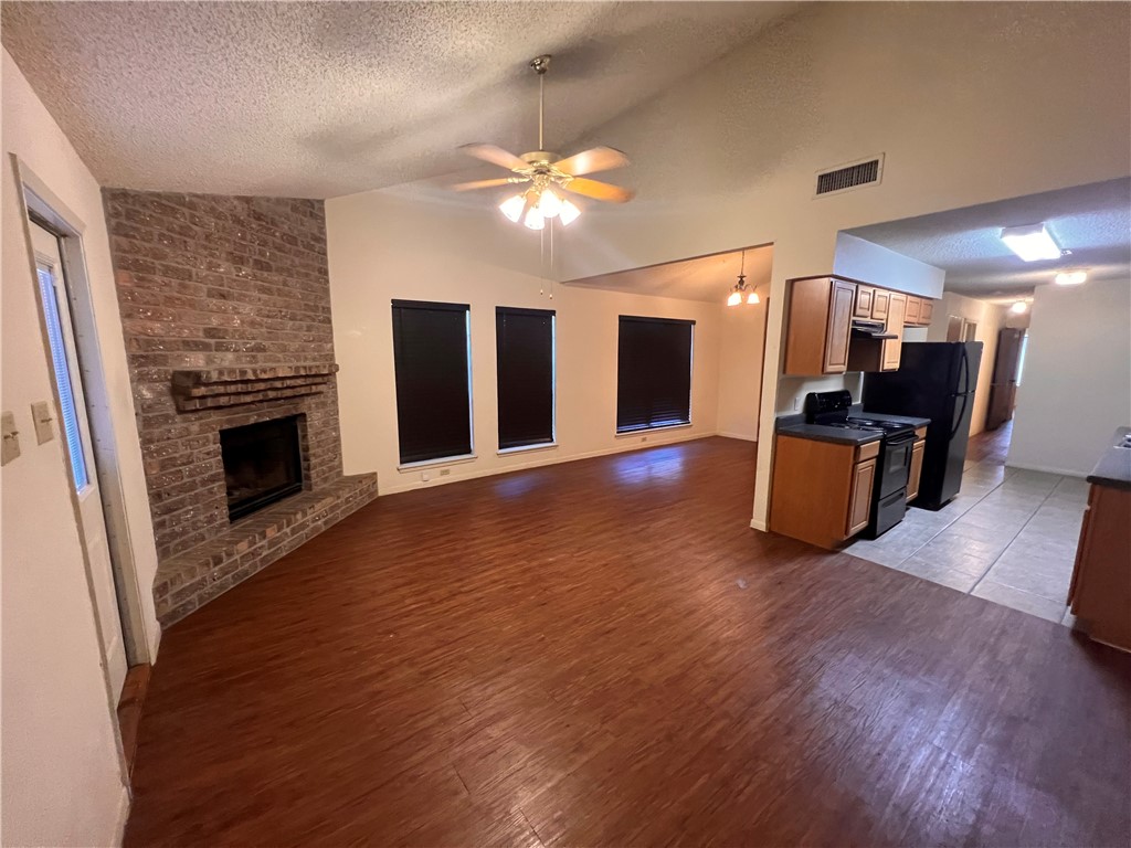 4021 Acushnet Drive, Unit F Corpus Christi, TX 78413 - Photo 4 of 21 a view of a livingroom with furniture a fireplace and wooden floor