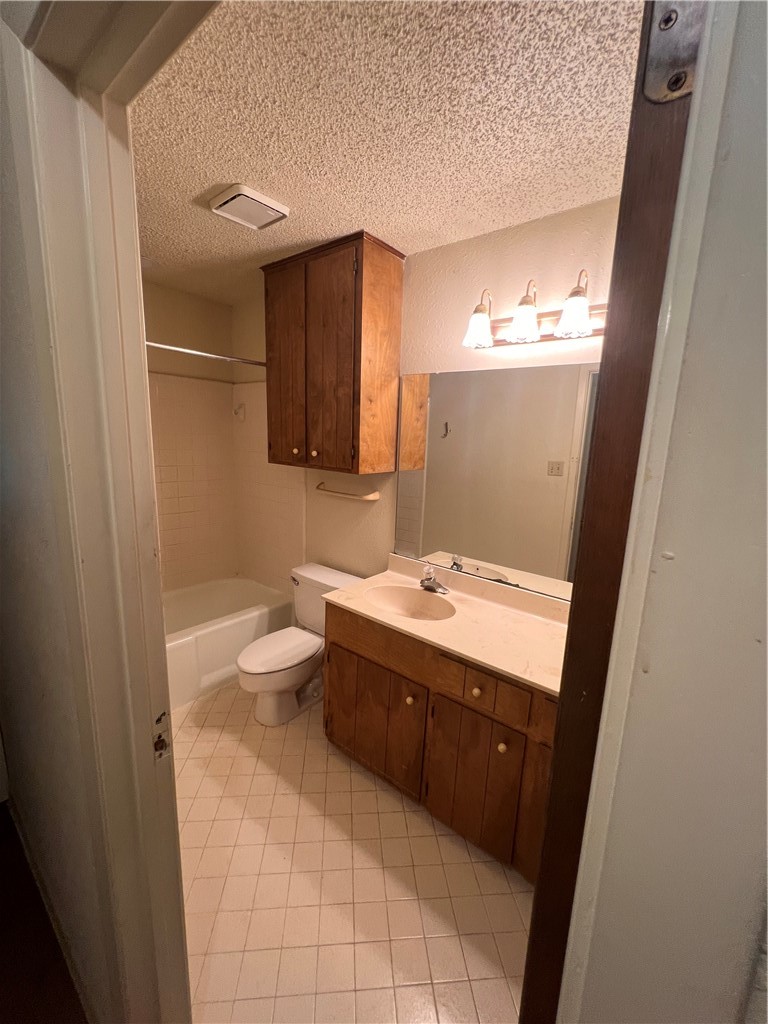 4021 Acushnet Drive, Unit F Corpus Christi, TX 78413 - Photo 9 of 21 a bathroom with a sink a toilet and mirror