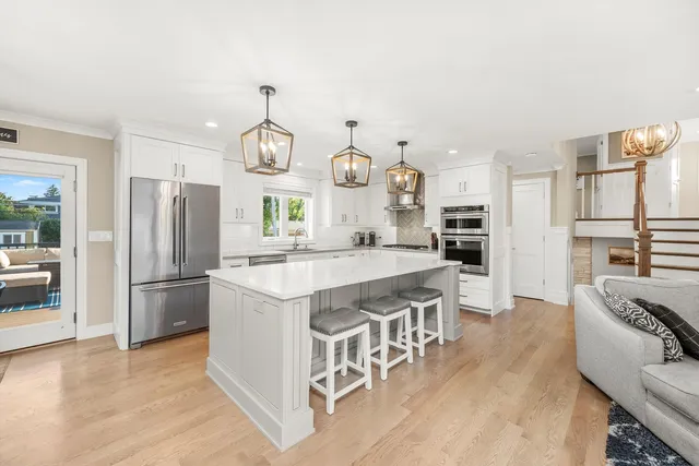 a kitchen with stainless steel appliances granite countertop a refrigerator a stove a sink and a refrigerator