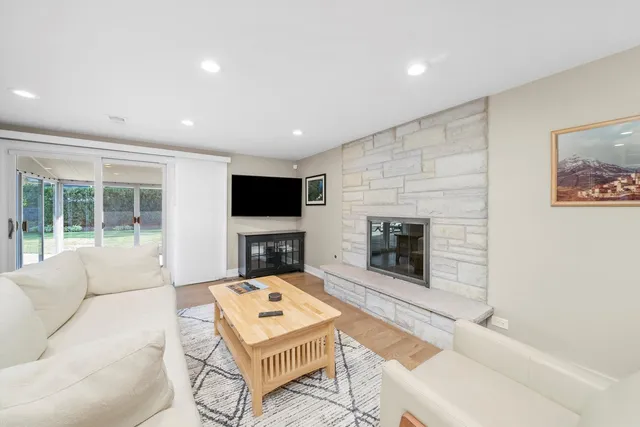a living room with furniture a rug and a flat screen tv