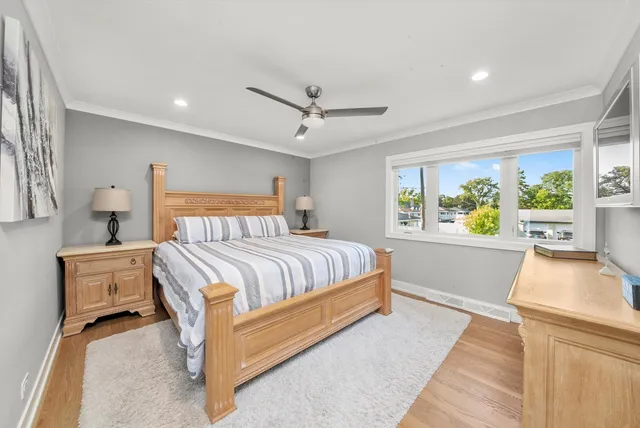 a bedroom with a large bed and a chandelier