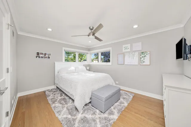 a spacious bedroom with a bed and a flat screen tv