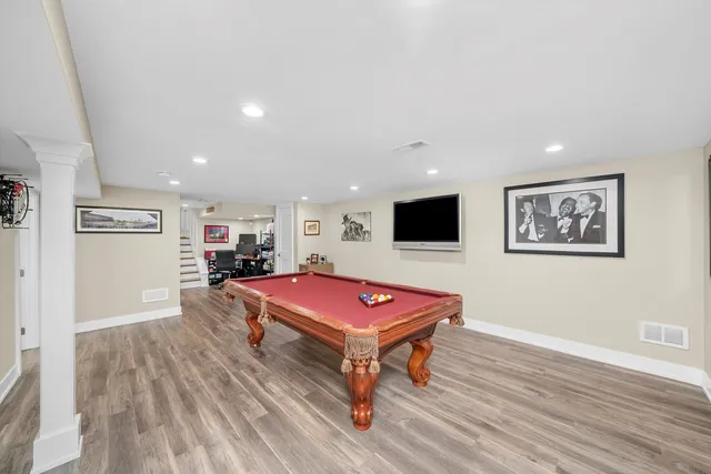 a room with furniture pool table and flat screen tv