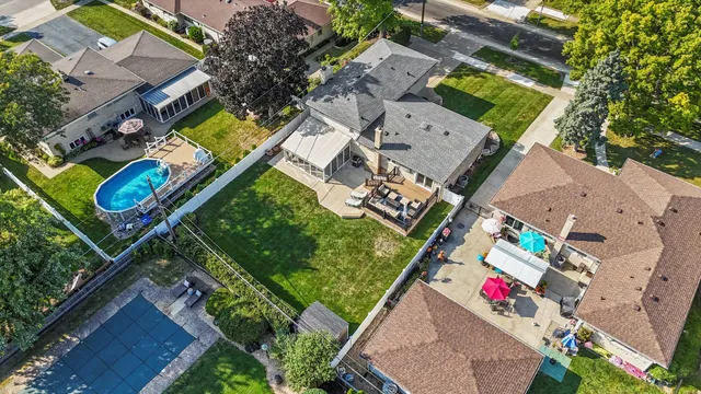an aerial view of residential house with outdoor space and swimming pool