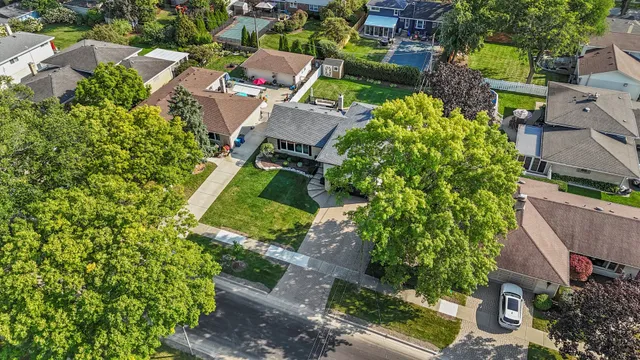 an aerial view of a house with a yard
