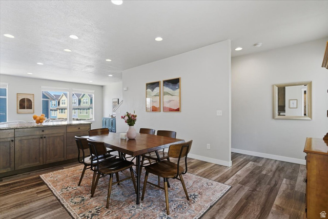 370 West Knights Lane Layton, UT 84041 - Photo 11 of 31 Open-concept dining area featuring wood-finish flooring, recessed lighting, and a built-in kitchen island with stone countertop