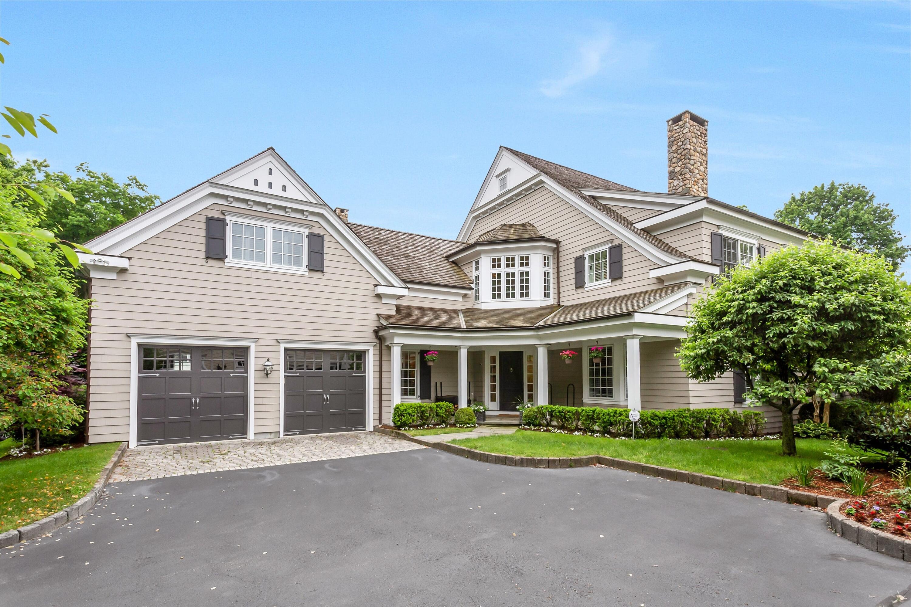 2 Harbor Bluff Lane Rowayton, CT 06853 - Photo 1 of 37 a front view of a house with a garden and plants