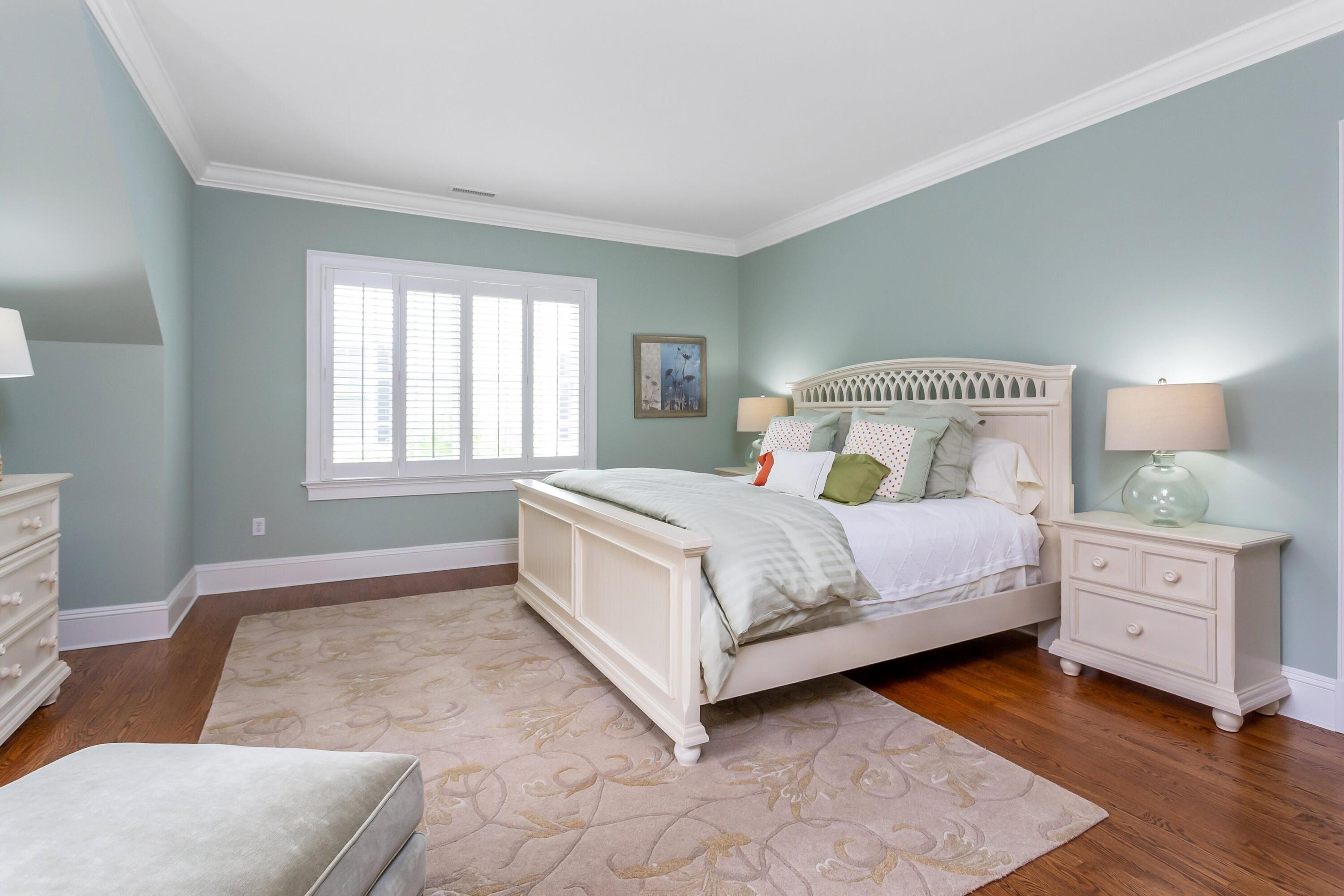 2 Harbor Bluff Lane Rowayton, CT 06853 - Photo 23 of 37 a bedroom with a large bed and a couch