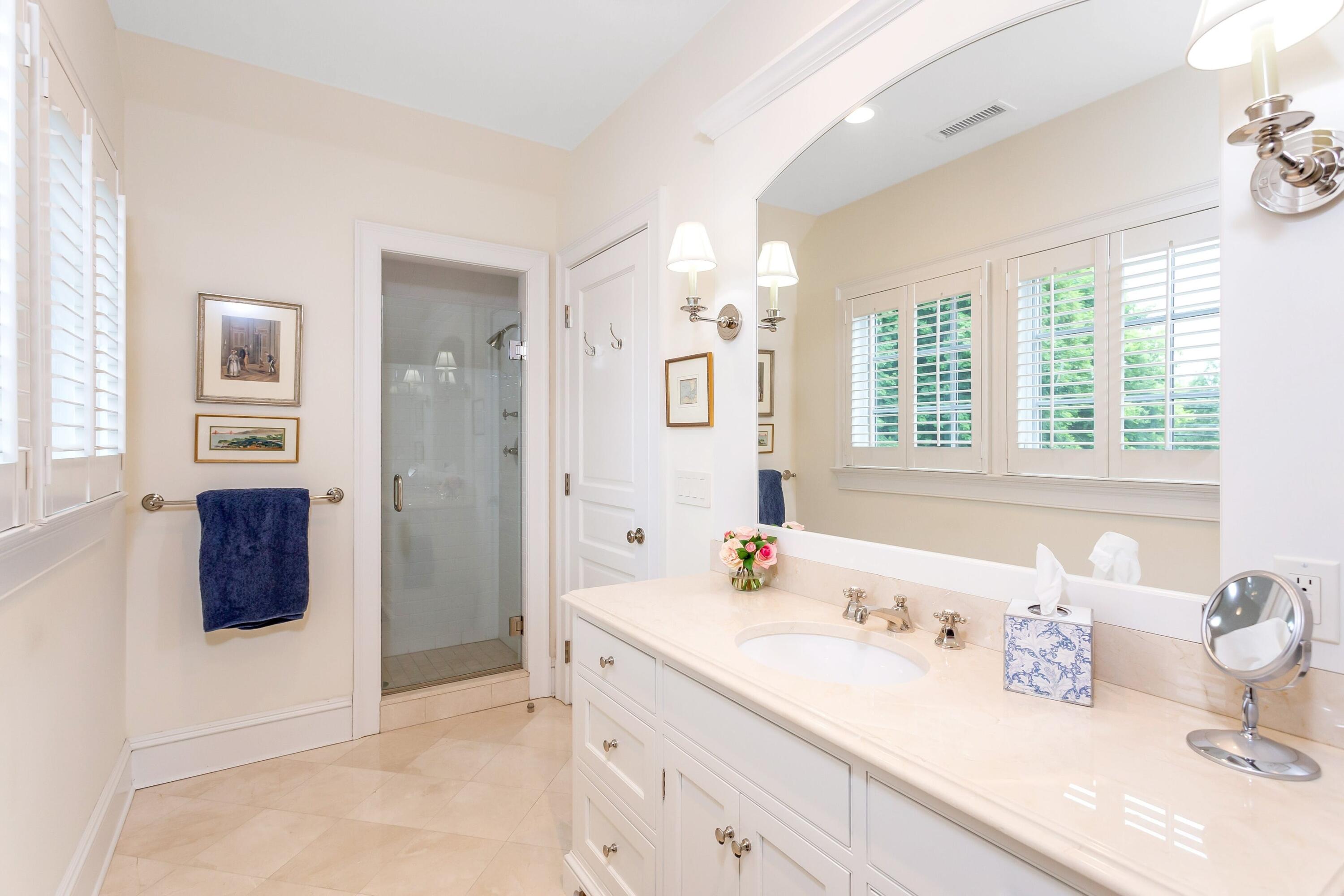2 Harbor Bluff Lane Rowayton, CT 06853 - Photo 26 of 37 a bathroom with a tub sink and mirror