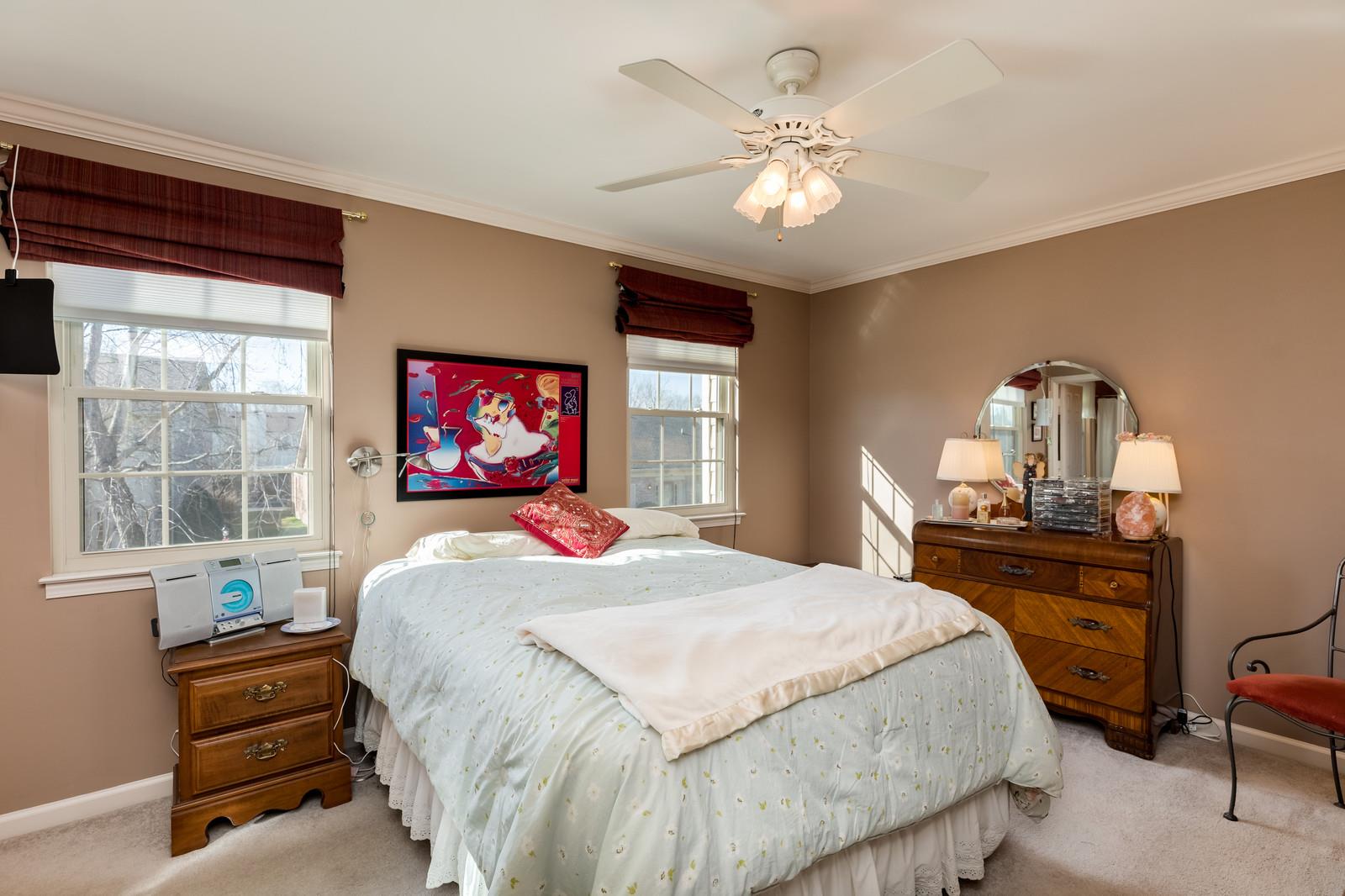 1306 General George Patton Road, Unit 1306 Nashville, TN 37221 - Photo 15 of 21 a bedroom with a bed and a chandelier