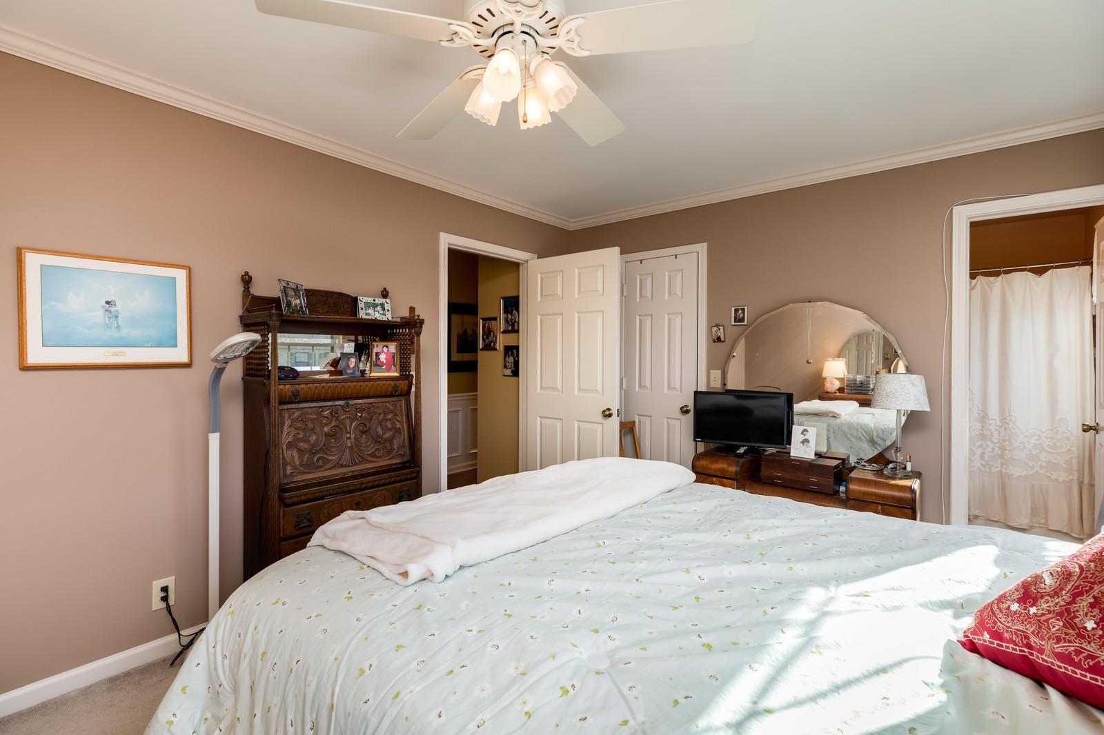 1306 General George Patton Road, Unit 1306 Nashville, TN 37221 - Photo 16 of 21 a bedroom with a bed and a chandelier