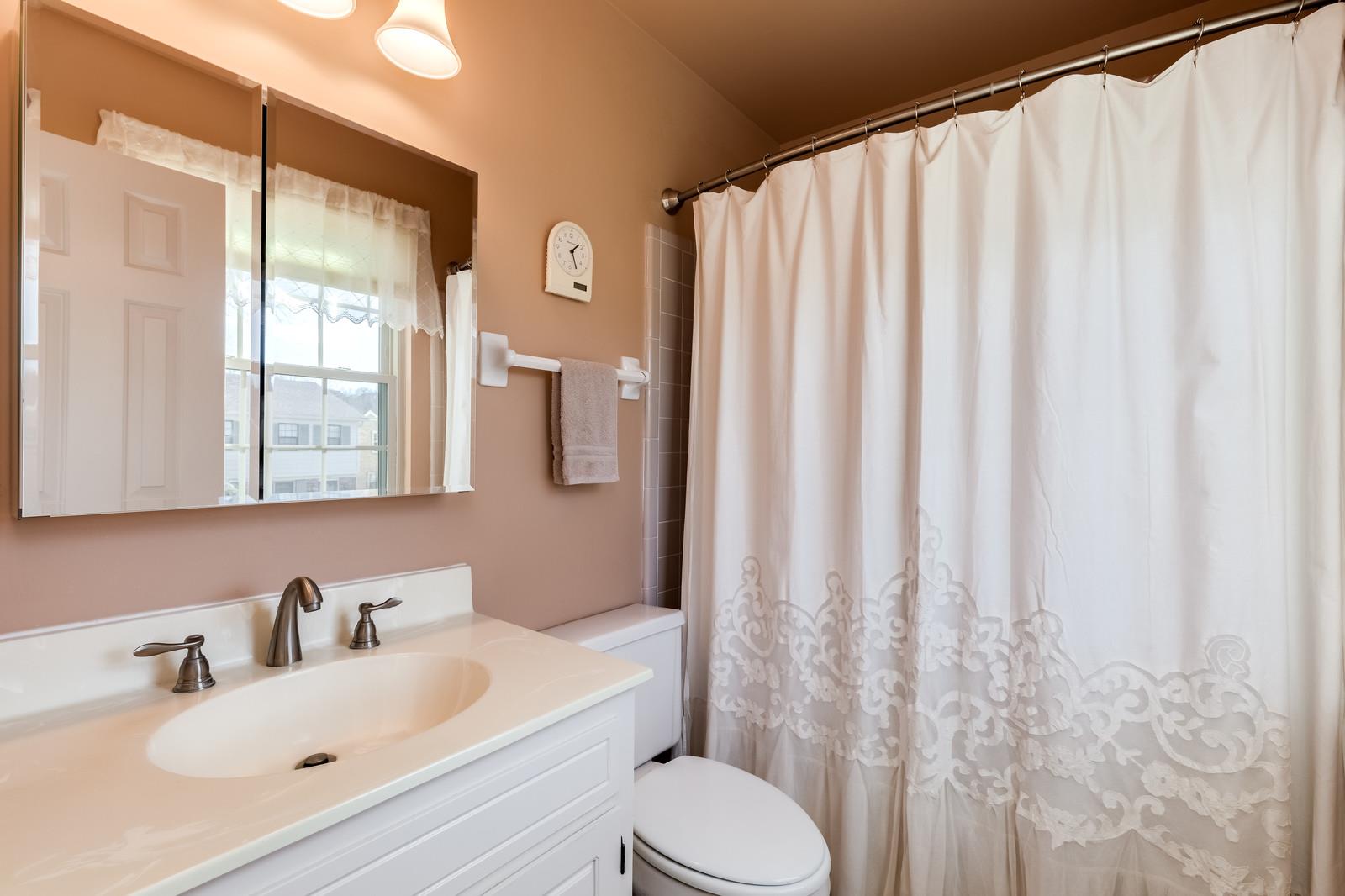 1306 General George Patton Road, Unit 1306 Nashville, TN 37221 - Photo 17 of 21 a bathroom with a sink toilet and shower