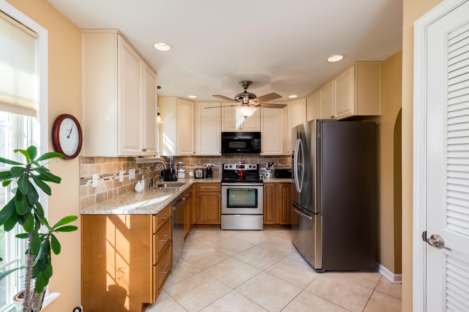 1306 General George Patton Road, Unit 1306 Nashville, TN 37221 - Photo 3 of 21 a large kitchen with a refrigerator a sink and a stove