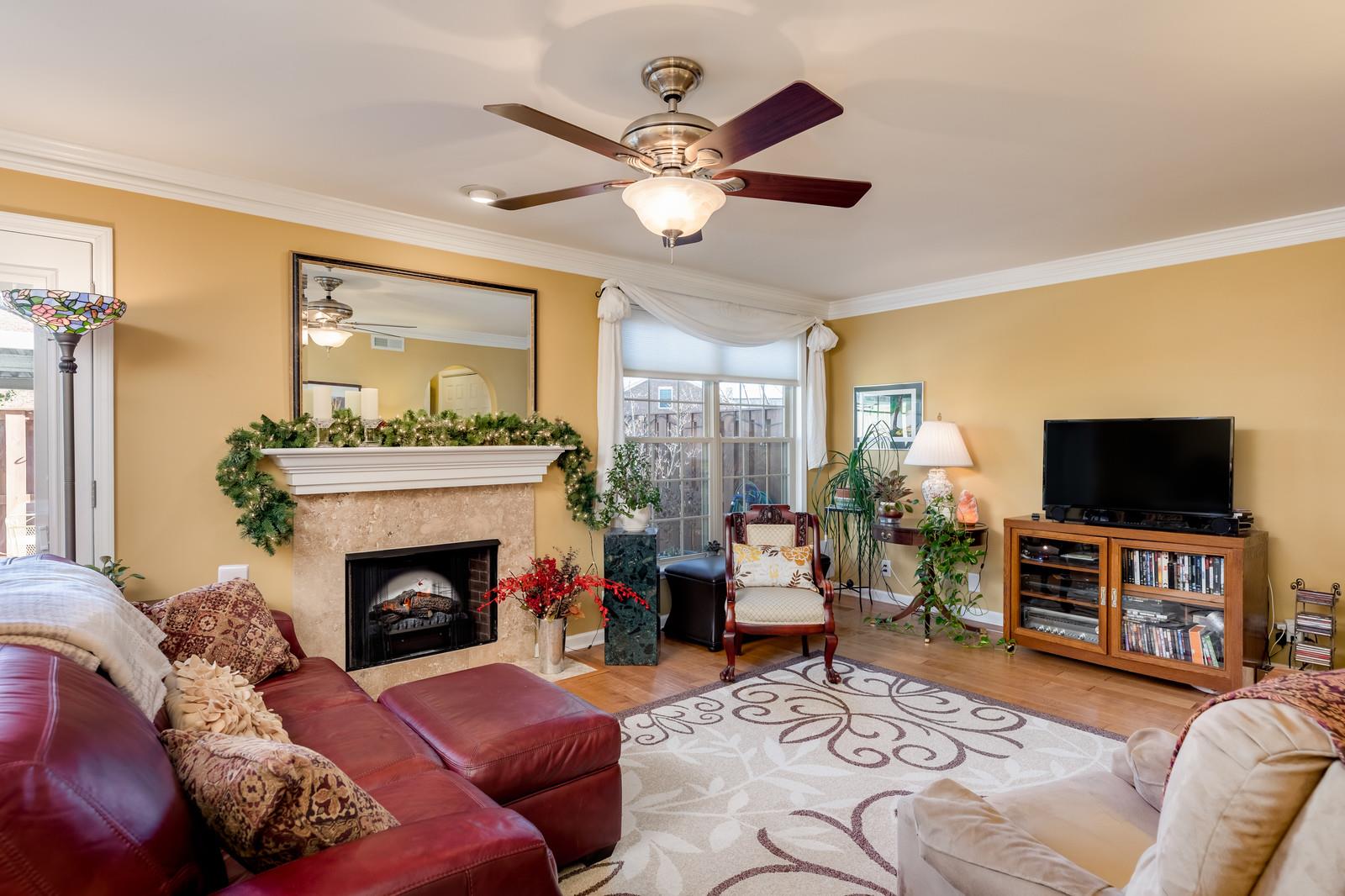 1306 General George Patton Road, Unit 1306 Nashville, TN 37221 - Photo 8 of 21 a living room with furniture a flat screen tv and a fireplace