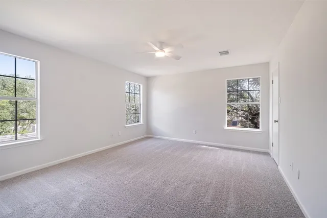 an empty room with windows and closet