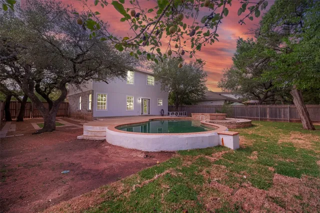 a view of an house with backyard space and sitting area