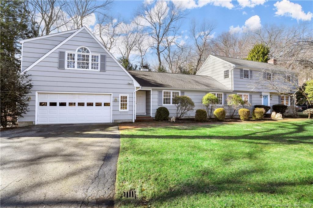 241 Mountain Laurel Road Fairfield, CT 06824 - Photo 1 of 1 a front view of a house with a garden and table