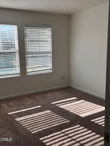 a view of a room with wooden floor and a window