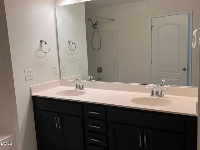 a bathroom with a double vanity sink mirror and double