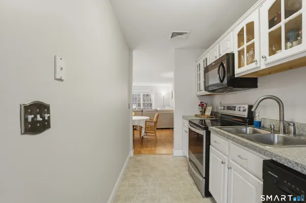 a kitchen with stainless steel appliances granite countertop a sink and cabinets