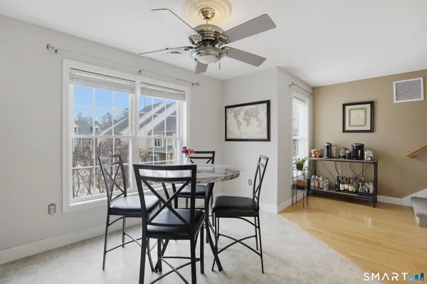 a view of a dining room with furniture and a chandelier