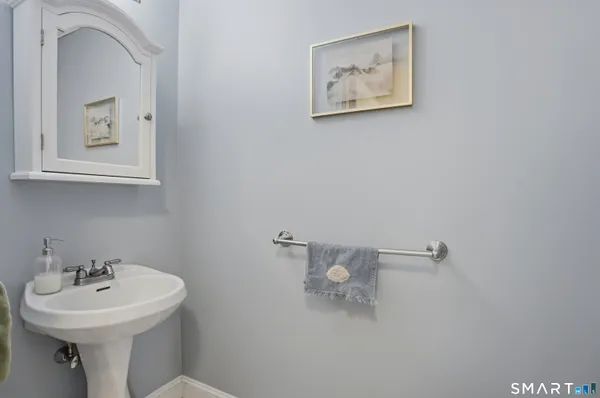 a bathroom with a sink mirror and toilet