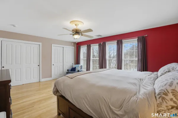 a bedroom with a large bed and a large window