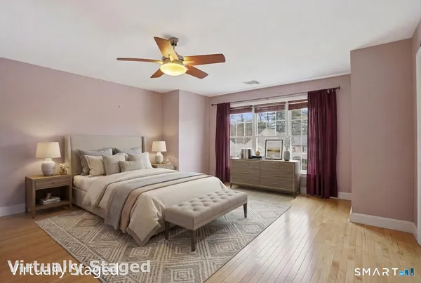 a bedroom with a bed mirror and window