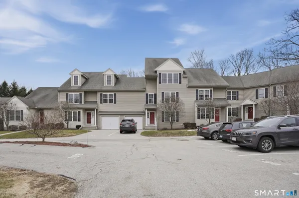 a car parked in front of a white house