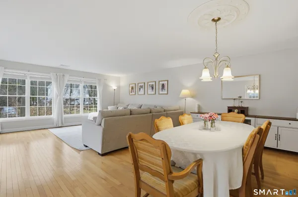 a view of a dining room with furniture window and wooden floor