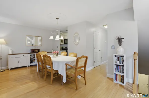 a view of a dining room with furniture and wooden floor