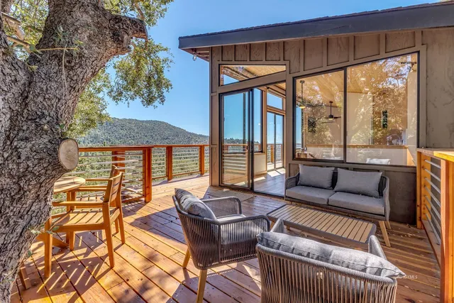 a view of a house with a patio and wooden fence