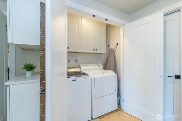 a view of storage and utility room with washer and dryer