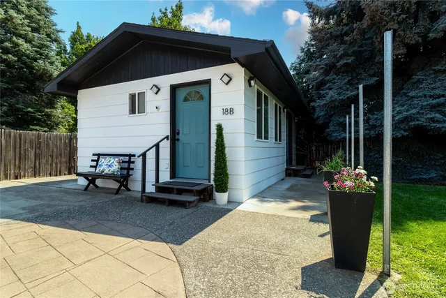 a kitchen with granite countertop a sink cabinets and window