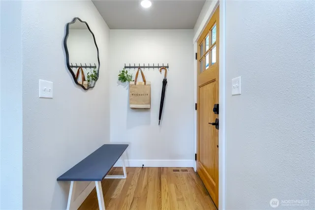 a bathroom with a wooden floor and a mirror