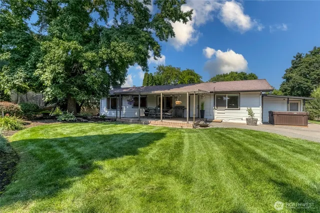 an aerial view of a house with garden space and sitting area