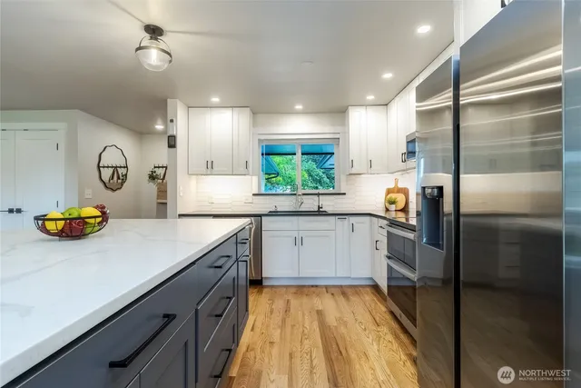 a kitchen with a refrigerator and a sink