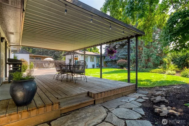 a view of a backyard with swimming pool table and chairs