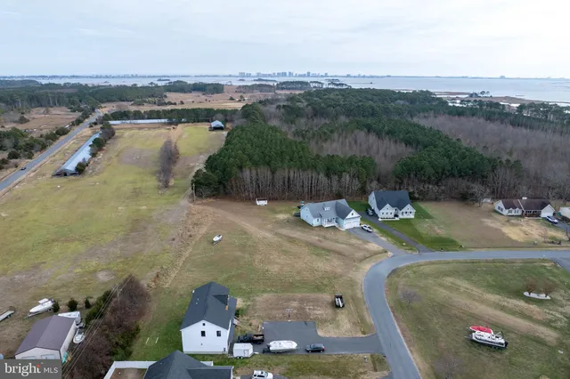 an aerial view of a house with a swimming pool yard and mountain view in back