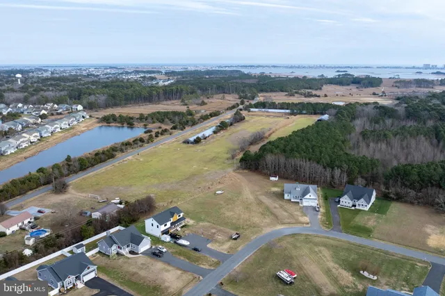 an aerial view of a house with a yard and lake view